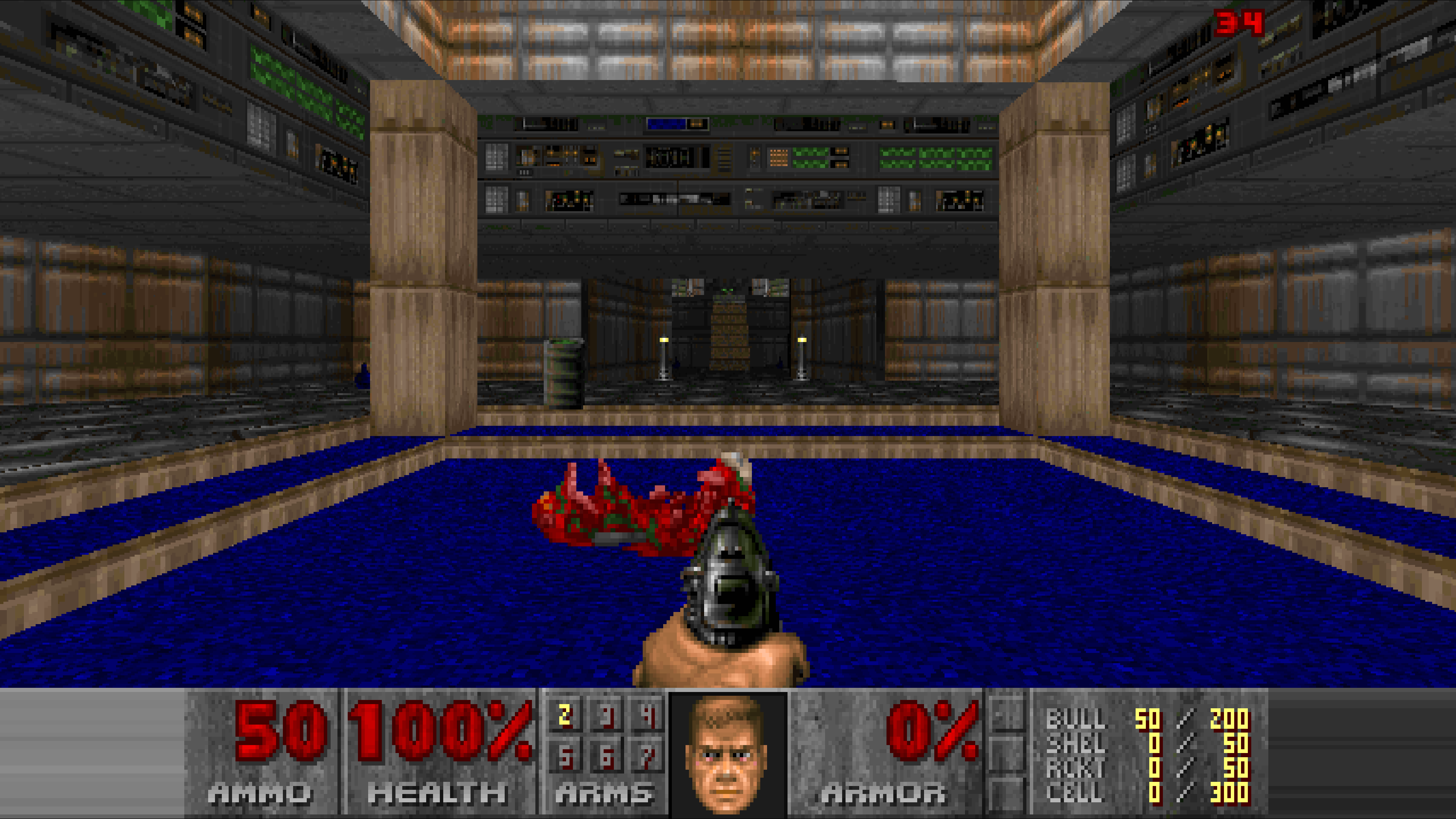 Classic DOOM gameplay in a widescreen view — a marine facing a computer-room level over a blue floor